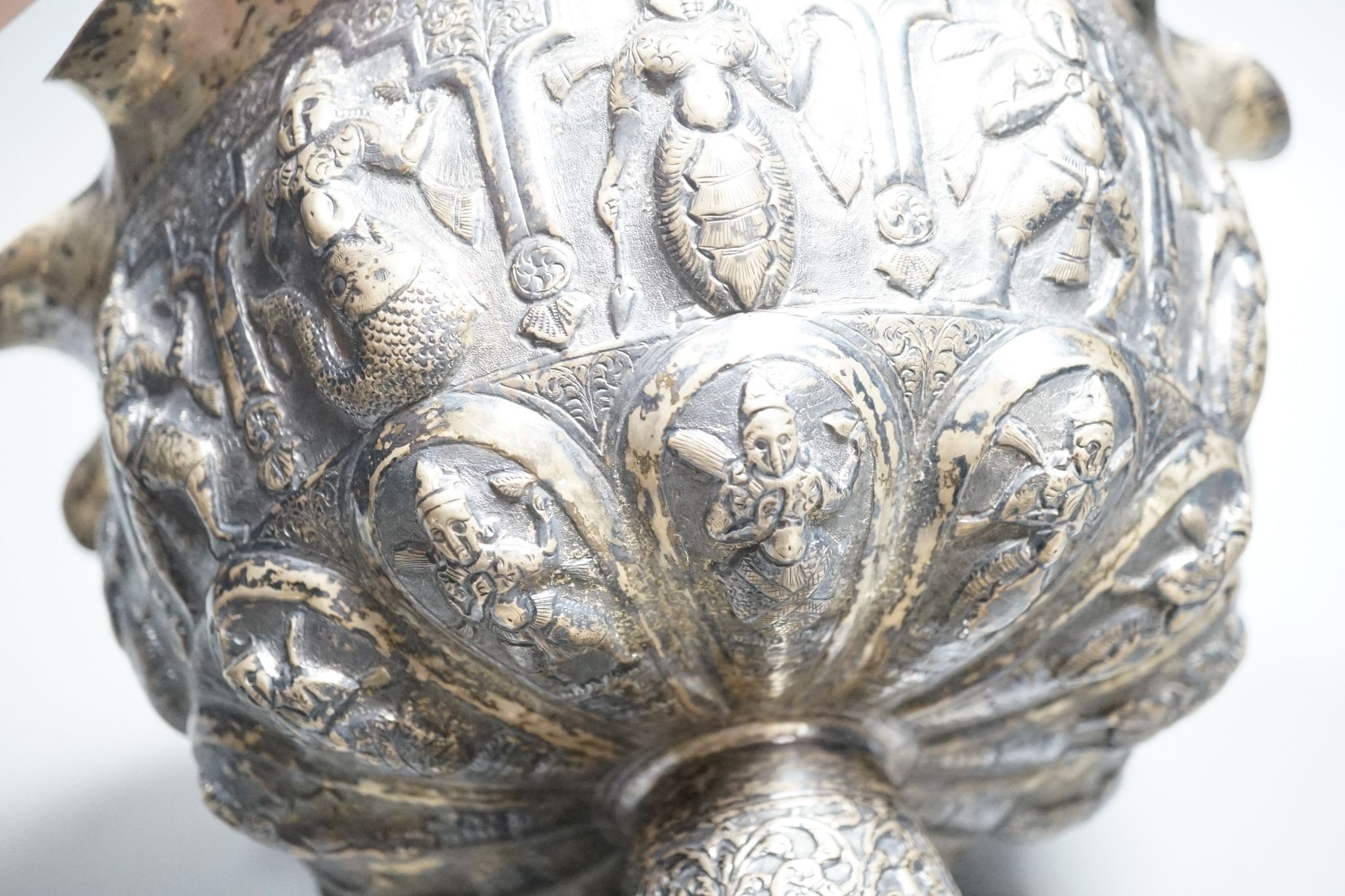 A late 19th century Burmese embossed white metal pedestal bowl, with wavy border, diameter, 27.2cm, 20.5oz.